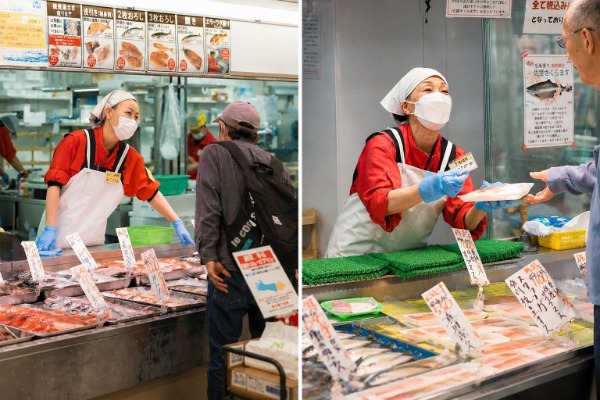 角上魚類の対面売場で接客する女性の親切係