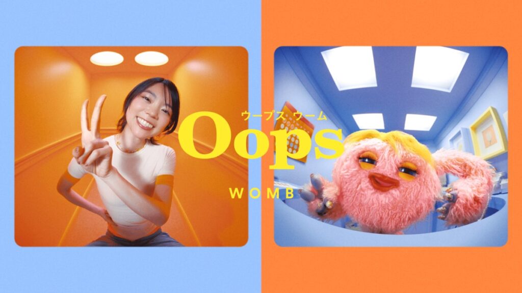 Oops WOMBのブランド初テレビCMのキービジュアル。女性とキャラクター「子宮のウーさん」